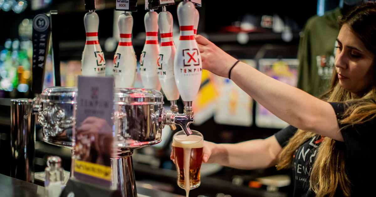 Bartender pouring a draft of Ten Pin Beer